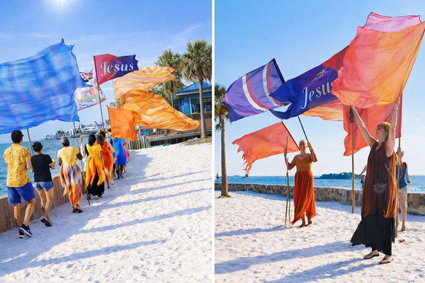 Worshippers celebrating Shavuot at Hudson Beach in Florida with worship flags.