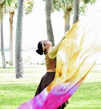 Kathia holding a hand-dyed Wisdom worship flag inspired by Psalm 111:10