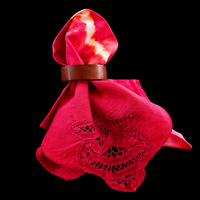 Sunburst tie-dye cotton napkin displayed in a napkin ring