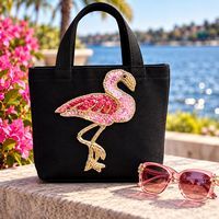 Pink Flamingo Sequin & Beaded Appliqué decorating a black tote bag with pink sunglasses beside it — WORSHIP WARRIORS®